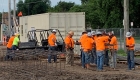 Construction Workers in Orange Shirts